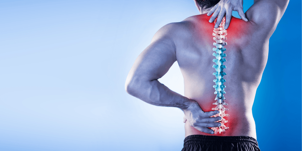 Man holding his back, you can visibly see a spine with red marks indicating pain points.